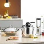 A collection of stainless steel kitchen utensils including spoons, ladles, whisks, and spatulas neatly arranged on a countertop.